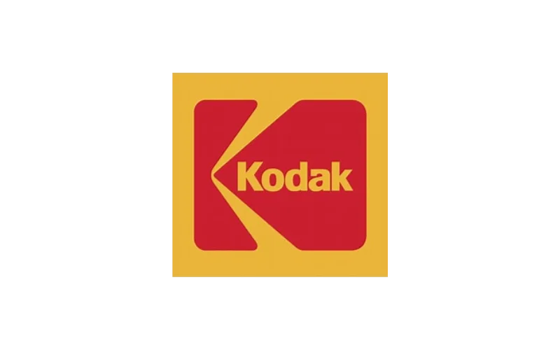 Close-up of a vintage Kodak logo with a yellow background and red emblem featuring the word 'Kodak' in yellow.